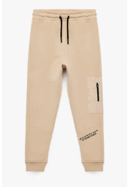 Pantaloni de trening din bumbac cu fenta cu fermoar - Bej